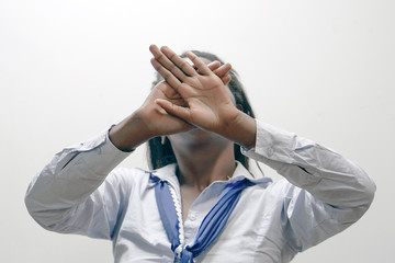 African woman hide her face at hand isolated on white background. Woman holding her hand stretched out toward the camera, covering her face, avoiding to be seen or stopping a problems     