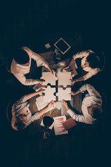 High angle above view vertical photo of four business people colleagues sitting table circle...