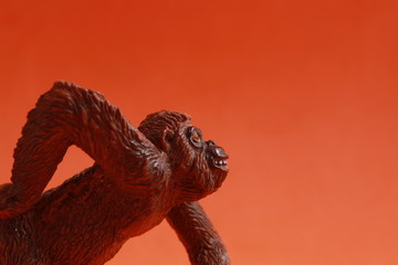 orangutan shaped plastic toy in color background