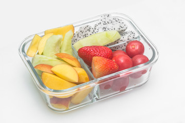 Cut fruit combinations are served in glass containers on a white background.