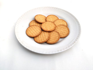 fresh healthy wheat biscuits put in a plate isolated on white background