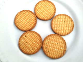 fresh healthy wheat biscuits put in a plate isolated on white background