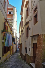 Fototapeta na wymiar A small street among the old houses of Sessa Aurunca, a medieval village in the province of Caserta