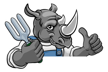 A rhino gardener cartoon gardening animal mascot holding a garden fork tool peeking round a sign and giving a thumbs up
