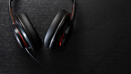 headphones on black table or background. flat lay. table top view. copy space. - musical concept