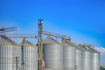 Agricultural Silos ,Industrial silos Storage and drying of grains with Blue Sky and White Clouds