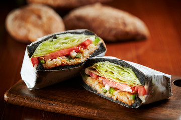 Black bread sandwich with baguette on background 