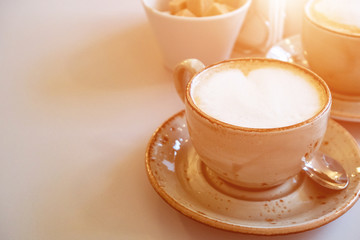 Two cups of cappuccino on the table