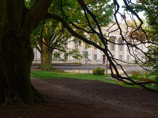 Old manor with columns in a green park. Wolsztyn, Poland