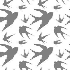 Fototapeta premium Freehand drawn gray silhouettes of swallows and pigeons in flight on white background. Design for decor, backgrounds, packaging, covers, cards and textiles.