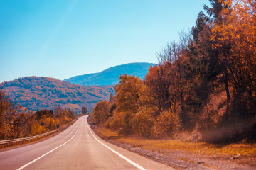 Mountain road on an autumn sunny day. Nature landscape