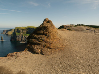 Cliff of moher, Rock formation, view on the Atlantic ocean, County Clare, Ireland. Warm sunny day. Blue cloudy sky.