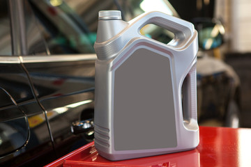 Engine oil canister with black label in a colorful blurred background the garage