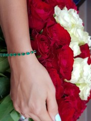 bouquet of roses in hand with a bracelet