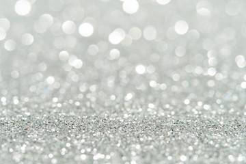 Silver Sparkling Lights Festive background with texture. Abstract Christmas twinkled bright bokeh defocused and Falling stars. Winter Card or invitation	
