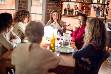 Beautiful group of women smiling happy and confident. Eating roasted turkey celebrating christmas at home