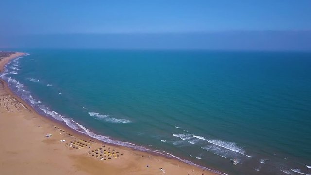 Beautiful View over Moroccan beach with waves and sand. Filmed with a drone.