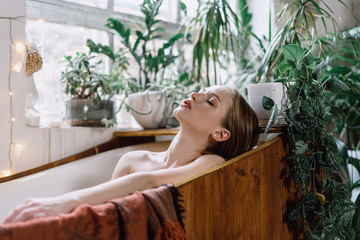Young adult woman taking bath at home