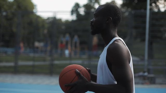 Muscly Afro-American Guy Throwing Succesfully Ball to Hoop Rejoicing Looking Happy and Satisfied at Street Basketbal Sports Field. Healthy Lifestyle and Sport Concept. 360 Video in Slow Motion.