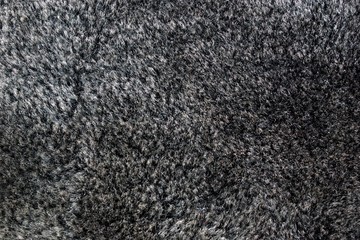 Fototapeta premium Artificial fur color anthracite-sewing textile material, imitating natural fur, wildlife protection. Used in the manufacture of clothing, hats, soft toys. Low cost, light weight.