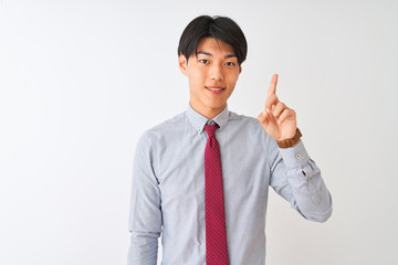 Chinese businessman wearing elegant tie standing over isolated white background showing and pointing up with finger number one while smiling confident and happy.