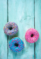 colorful doughnuts on turquoise surface
