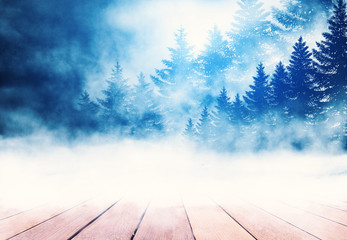 Winter abstract background. Empty wooden snowy countertop. Winter forest, moon, fog in the background