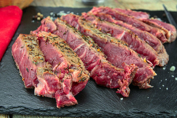 rib of beef grilled in slice on a wooden table