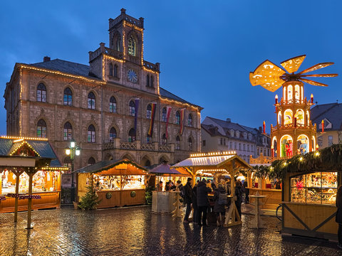Weimar, Germany. Christmas market at Market Square in front of Town Hall in twilight.