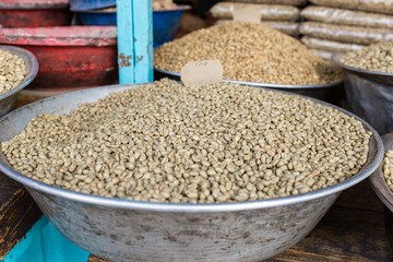 Green unroasted coffee beans for sale in a market