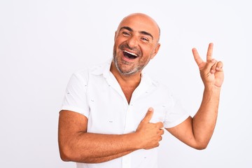 Middle age handsome man wearing elegant shirt standing over isolated white background smiling with happy face winking at the camera doing victory sign. Number two.