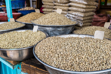 Green unroasted coffee beans for sale in a market
