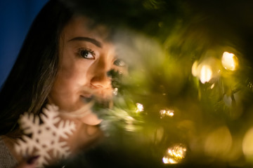 Beautiful asian girl in christmas decorated home at evening