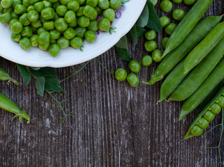 fresh pea on dark wooden surface