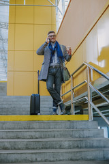 Fototapeta premium Handsome elegant man talking on cellphone and smiling