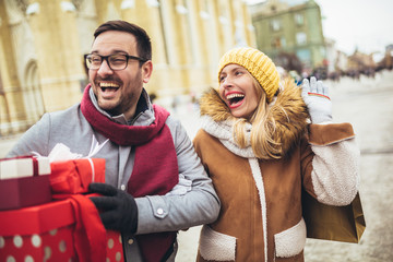 Young couple doing Christmas shopping in the city
