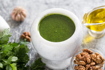 Homemade parsley pesto sauce and ingredients. Vegan healthy food.