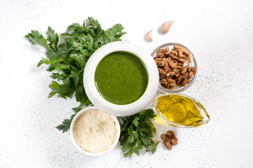 Homemade parsley pesto sauce and ingredients. Vegan healthy food.