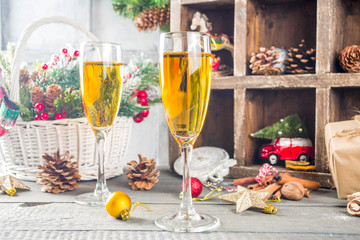 Two champagne glasses with christmas decoration on wooden snow background. Happy New Year and  christmas Celebration.