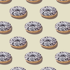 Food seamless isometric pattern with white glazed chocolate donuts on pastel beige background.Dessert fast food.Minimal abstract creative concept.Photography collage.Square image