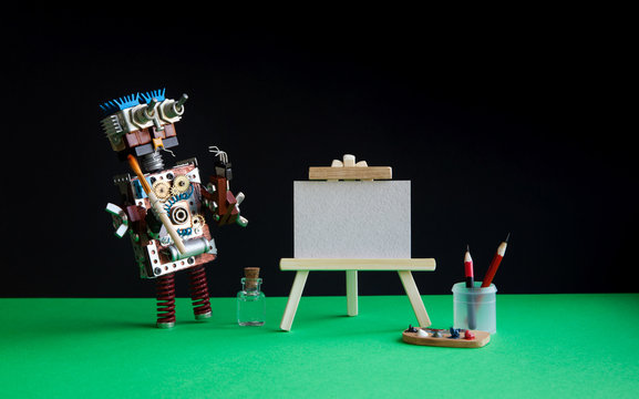 Robot artist begins to create a drawing with a brush. White paper template, wooden easel, palette and painter accessories. Black green background.