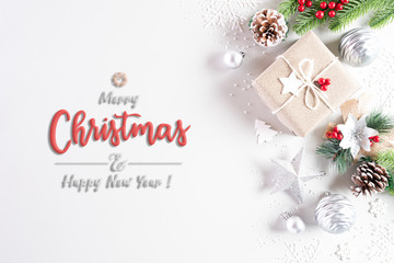 Christmas holidays composition Top view of gift box with Christmas tree decoration and red berries on white background with copy space for text.