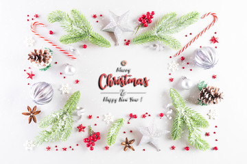 Fototapeta premium Christmas holidays composition Top view of gift box with Christmas tree decoration and red berries on white background with copy space for text.