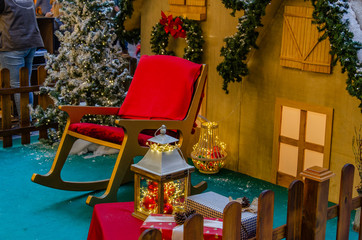Christmas decoration at Shopping Center. Santa´s house, lamp, chear.