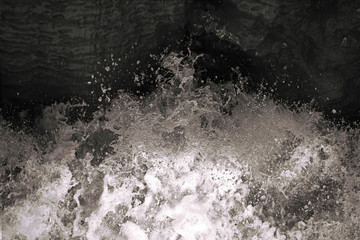 Water splash in black and white. Darkness ans shadow. Water in dynamic motion. Monochrome abstract background.