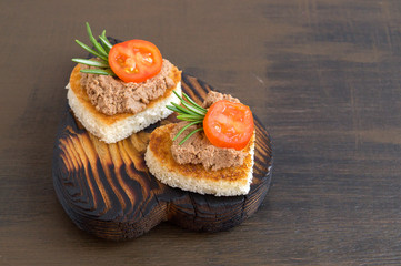 fried bread with meat pate in the shape of a heart.