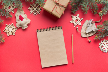 Zero waste Christmas concept. Goals, checklist, plans for New Year. Wish list for 2020 year with wooden decor on red. Top view. Flat lay.