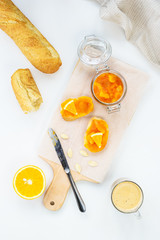 Sandwiches with pumpkin and orange jam on a wooden board.
