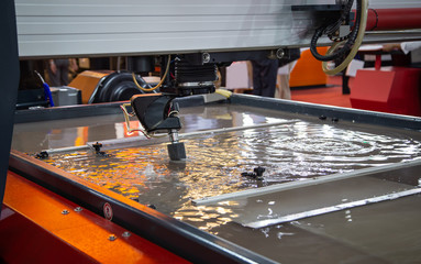 Modern industry CNC abrasive water jet cutting machine using hihn pressure water jet to cut metal....
