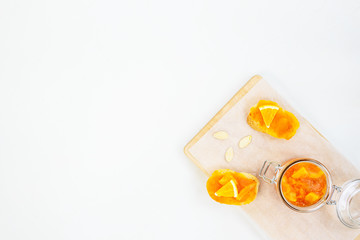 Sandwiches with pumpkin and orange jam on a wooden board.